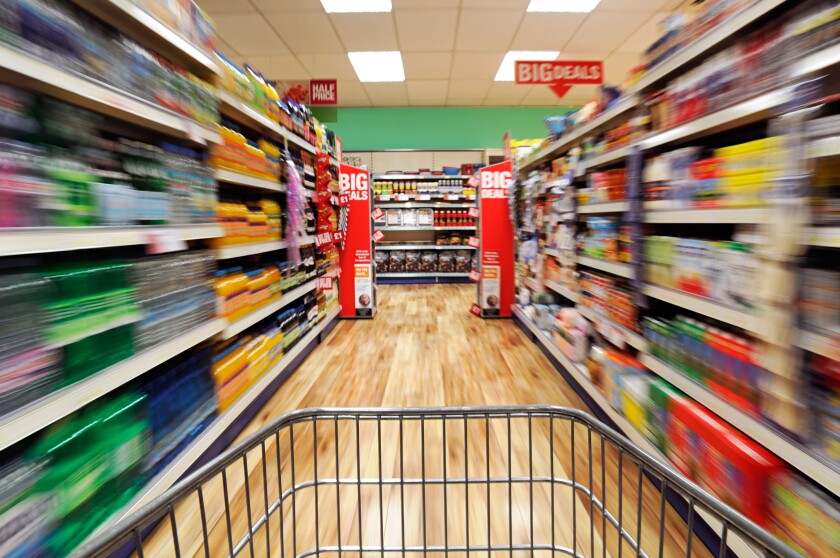 Shopping Trolley Speeding Down a Supermarket Aisle, UK.