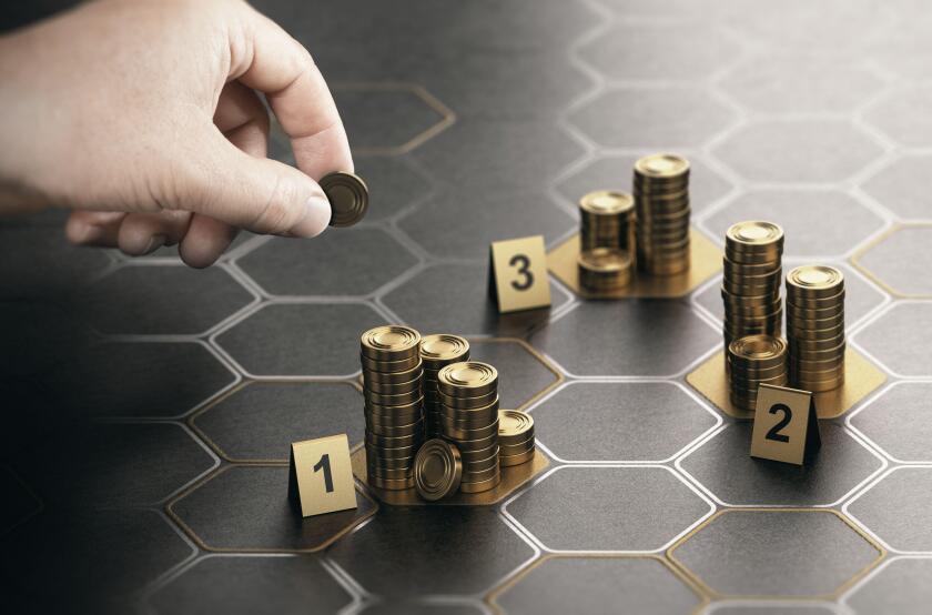 Human hand stacking generic coins over black background with hexagonal golden shapes. Concept of angel investor and investing in startup companies. Co
