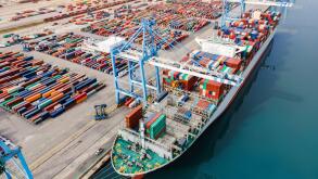 Container ship being loaded and unloaded at terminal freight port, international shipping and global commerce, modern cargo harbor and yard for mariti