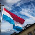 Luxembourg flag flying among historic buildings in the capital