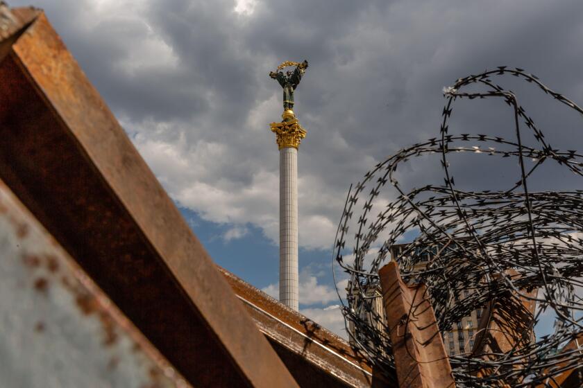 Kyiv, Ukraine. 9th June, 2022. The Independence monument on the Maidan Square is seen through metal road barricades and barbed wire in the Old Town of Kyiv. As the Russian Federation invaded Ukraine 3 and a half months ago, fierce fighting continues in th