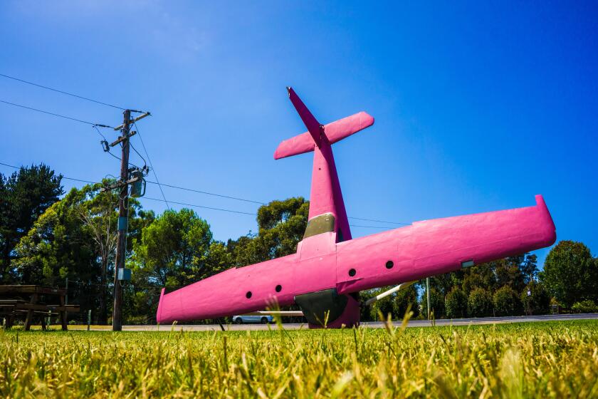 An old light aircraft sculpture at a remote service station in Australia