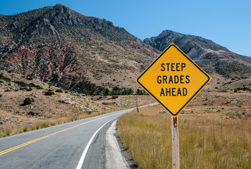 Steep Grades Warning Sign:  A sign warns of a steep climb ahead on a road leading into the Big Horn Mountains of northeastern Wyoming.