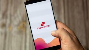 A mobile phone or cell phone being held by a hand with the Express VPN app open on screen