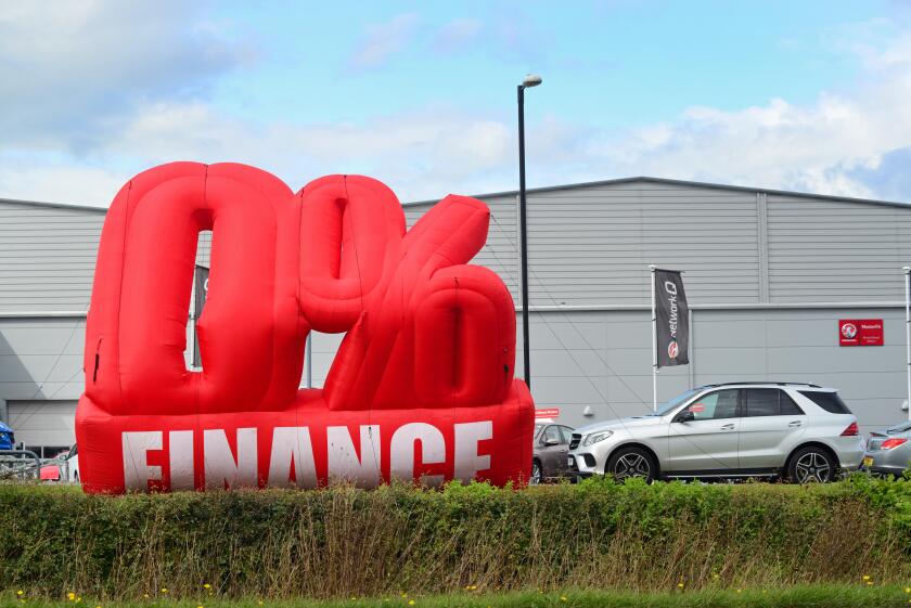 advertisement of zero percent finance available outside car dealership knaresborough yorkshire united kingdom