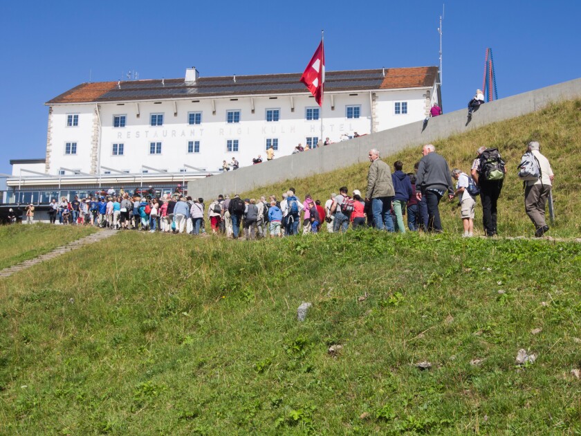 Rigi Kulm hotel and restaurant at the top of Rigi mountain in Switzerland, crowd of tourists ascending from the railway station