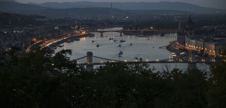 The Chain Bridge and the House of Parliament, right, are seen after turning off their illumination lights as part of nationwide energy-saving measures, in Budapest, Hungary, Tuesday, Aug. 4, 2026. (Zsolt Szigetvary/MTI via AP)