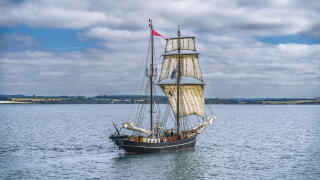 Classic maritime vessel in serene seascape.