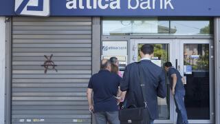 People line up at an ATM outside an Attica Bank branch in Athens, Greece on July 8, 2015.  Greece asked for more funds from the European Union as it prepared a last ditch effort on economic reforms to stay in the Euro before a fast-approaching deadline.  