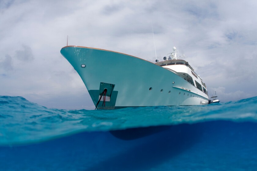 A split water view of a yacht in the Bahamas.
