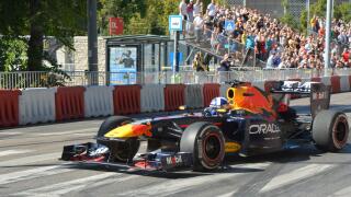Former F1 driver David Coulthard driving the Red Bull Racing RB7 Formula 1 car during the Red Bull Showrun in Budapest, with crowds and photographers