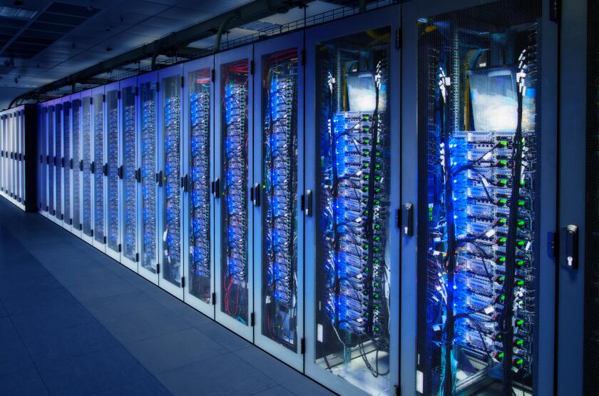 Network cabinets with server racks in a data center. Digital Composite (DC)