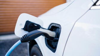 Power cord charging electric car at station