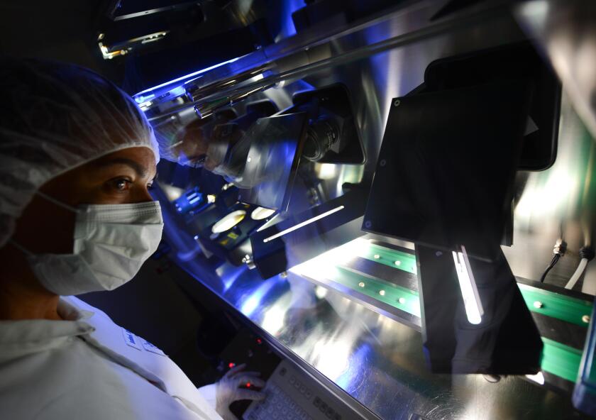 Darmstadt, Germany. 25th June, 2014. The photos released by pharmaceutical and chemical company Merck KGaA shows employee Isabel Ribeiro at the optical final checking station in Merck Pharma Production in Darmstadt, Germany, 25 June 2014. Six special came