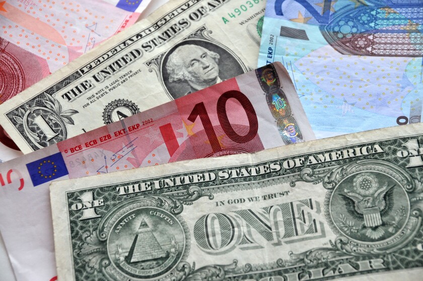Paper money of American dollars and euro notes.