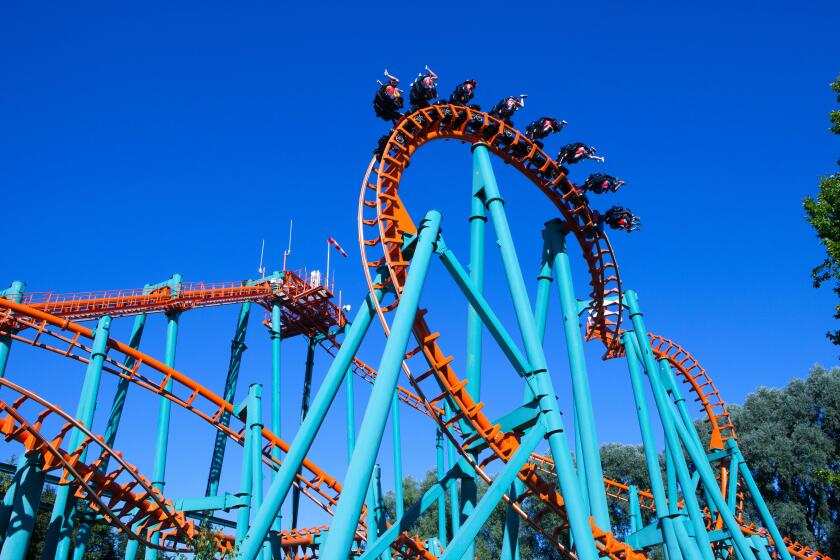 Orange rollercoaster with blue sky in the background