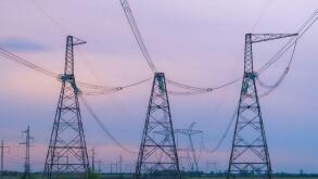 Industrial background group silhouette of transmission towers or power tower, electricity pylon, steel lattice tower at purplr sunset. Texture of high