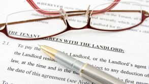 pen,glasses and tenant agreement with the landlord