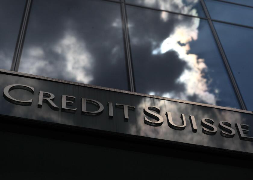 A cloud is mirrored in the facade of the Credit Suisse bank in Frankfurt July 14, 2010. Prosecutors are searching Credit Suisse offices in 13 German cities after evaluating a compact disc with names of alleged tax evaders, prosecutors in Duesseldorf, Germ