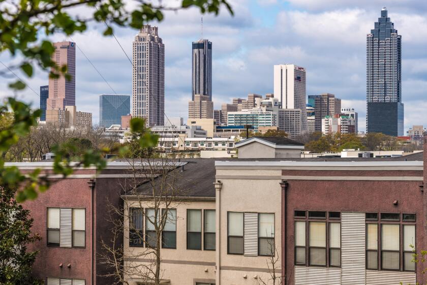 Atlanta, Georgia skyline beyond urban residential area on the east side of the city. (USA)