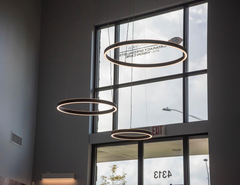 Large circular lights hanging from the ceiling inside a doctor's office entrance.