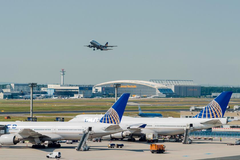 An aeroplane of the airline Lufthansa is taking off at Frankfurt International Airport, two more aeroplanes are parking on the g