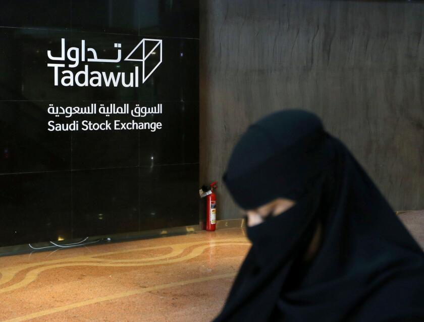 A Saudi woman walks at the Saudi stock market (Tadawul), in Riyadh, Saudi Arabia March 9, 2020.  REUTERS/Ahmed Yosri