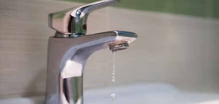 Traditional silver tap dripping. Broken faucet in the tub dripping water. Leaking plumbing. Wasteful water consumption. the concept of saving water.