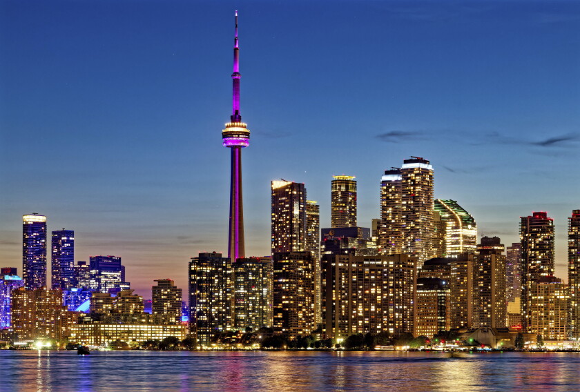 CN Tower dominates skyline of Harbourfront and Downtown Toronto, viewed from Wards Island.