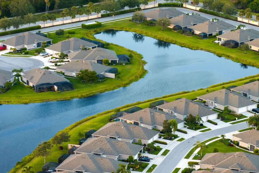 American gated community houses in rural US suburbs. View from above of large residential homes in small town in southwest Florida.