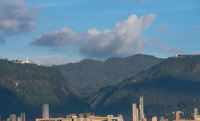 A beautiful view of a mountainous landscape with high and modern buildings in Bogota, Colombia