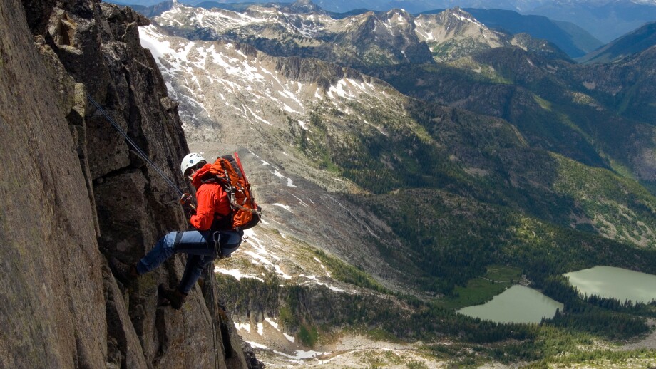 Male alpine rock climber steep cliff Kane Peak