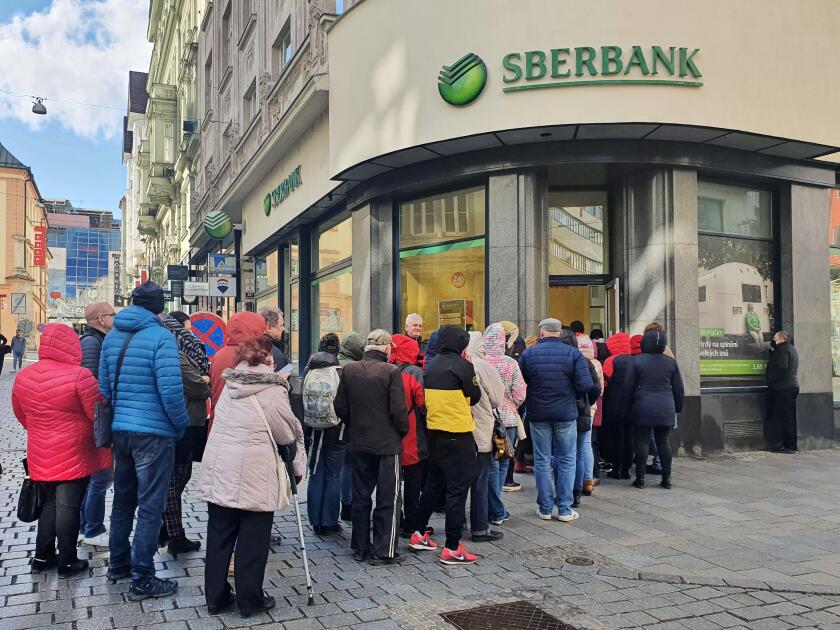 People waiting in line outside the branch of Russian bank Sberbank in Brno, Czech Republic, February 25, 2022. In connection with the Russian army's a