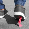Foot stuck into chewing gum on street