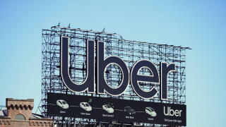 Manhattan, NY - April 9, 2023: New York City Uber car service billboard on top of building