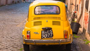 Two classic Fiat 500 cars parked on Trastevere backstreet, Rome, Lazio, Italy.