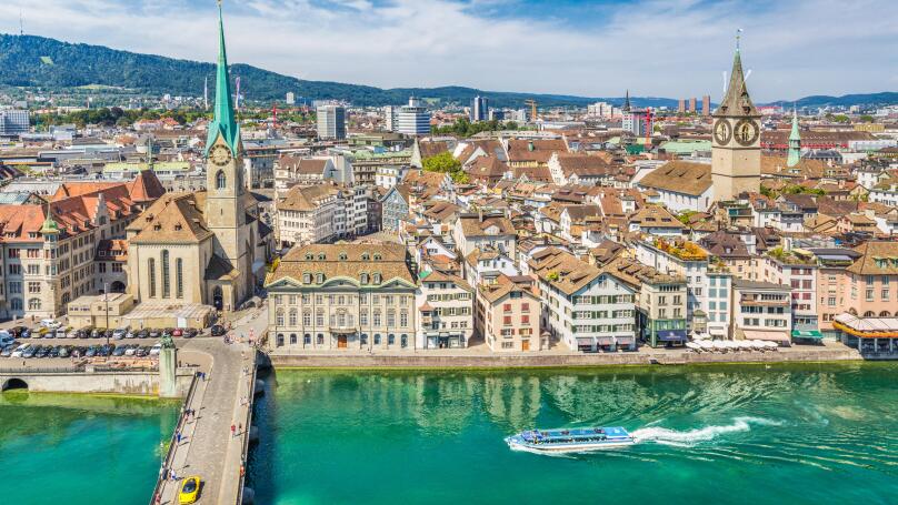 Aerial view of Zurich city center with famous Fraumunster and Sankt Peter Churches and river Limmat at Lake Zurich seen from Grossmunster, Switzerland