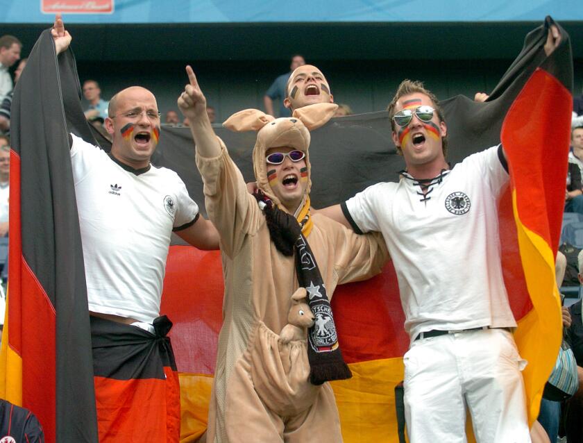 (dpa) - German soccer fans cheer prior to the match Germany vs Australia at the FIFA Confederations Cup in Frankfurt, Germany, 15 June 2005. Fan in center wears a kangaroo costume.