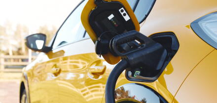 Close up of power supply plugged into an electric car being charged using a rapid charger cable
