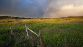 Rainbow and passing storm North of Calgary, Alberta, Canada.