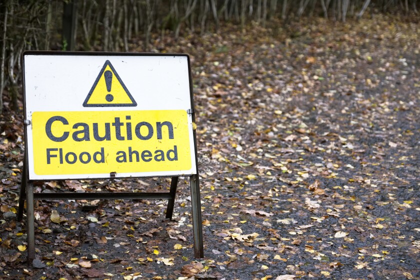 Flood ahead caution warning road sign water risk for drivers