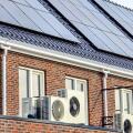 Air source heat pump unit installed outdoors at a modern home with solar panels in the Netherlands