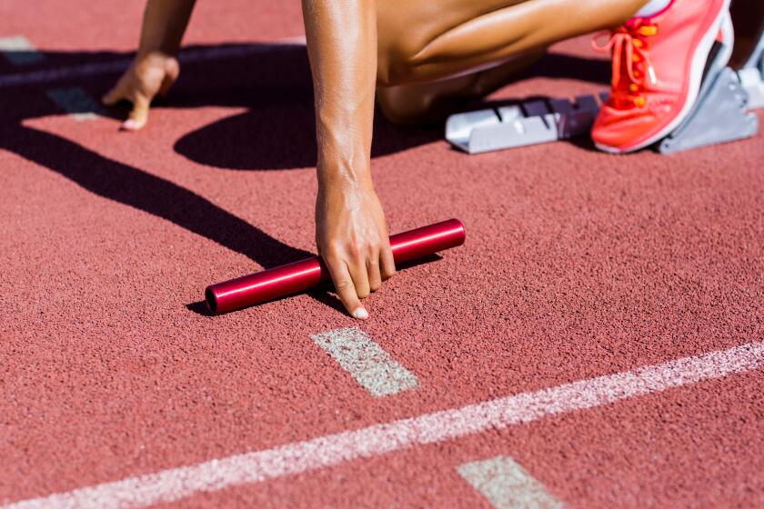 Female athlete ready to start the relay race