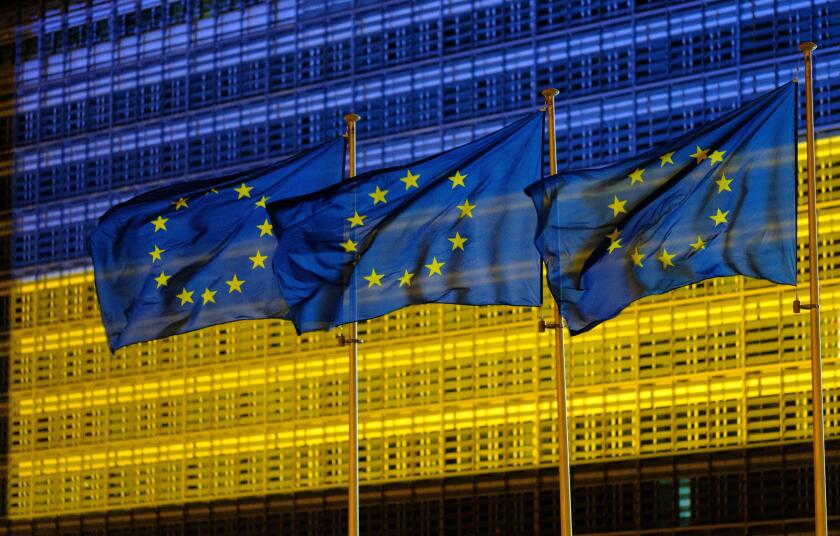 Belgium, Brussels, May 2022: facade of the Berlaymont building , headquarters of the European Commission, lit up in the colours of the Ukrainian flag.