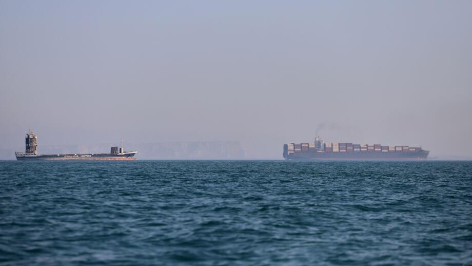 A container ship, right, and a cargo vessel are seen in the Strait of Hormuz off Bandar Abbas, Iran, Wednesday, June 17, 2026. (Amirhosein Khorgooi/ISNA via AP)