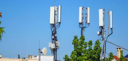 Mobile phone masts above rooftops, Fethiye, Turkey