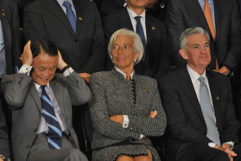 Buenos Aires, Argentina. 21st July, 2018. Finance Minister of Japan Taro Aso, Managing Director of the International Monetary Fund Christine Lagarde and Chairman of the Federal Reserve Jerome Powell during the Official family photo of the G20 3rd Meeting 
