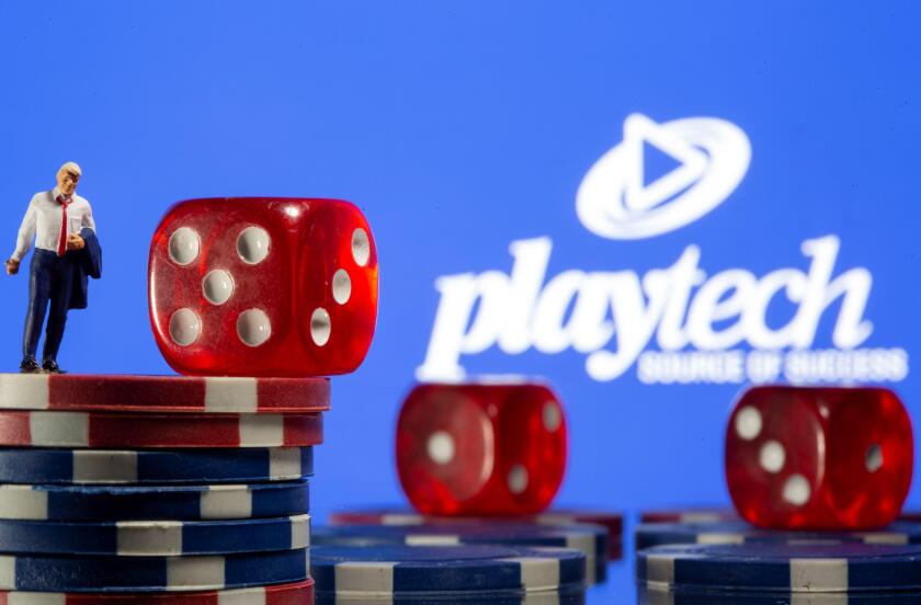 Businessman toy figure is placed on gambling chips in front of displayed Playtech logo in this illustration taken, November 8, 2021. REUTERS/Dado Ruvic/Illustration
