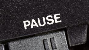 Macro close up photograph of vintage tape machine play and record pause button.
