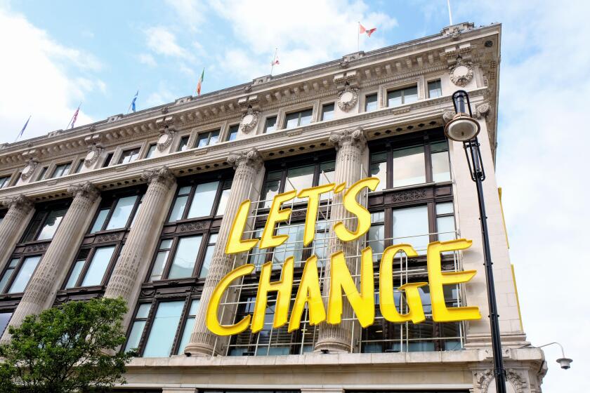 Let's Change the Way We Shop sign outside the Selfiedges store in Oxford Street aiming to improve sustainability business practices.